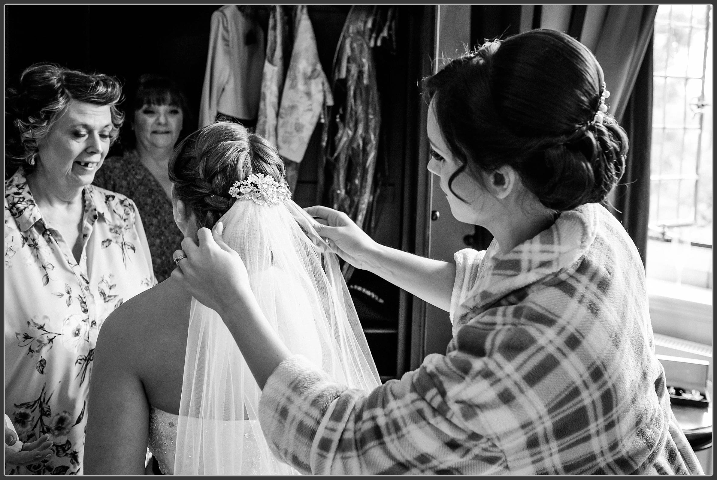 The bride having her veil attached