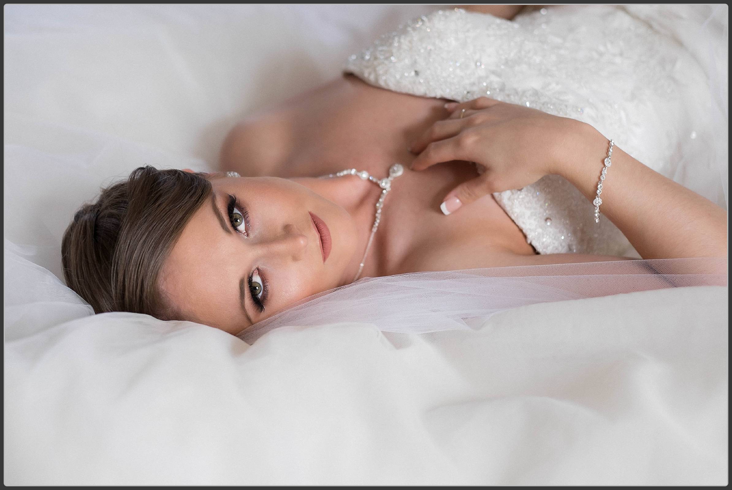 The bride lying on her wedding dress