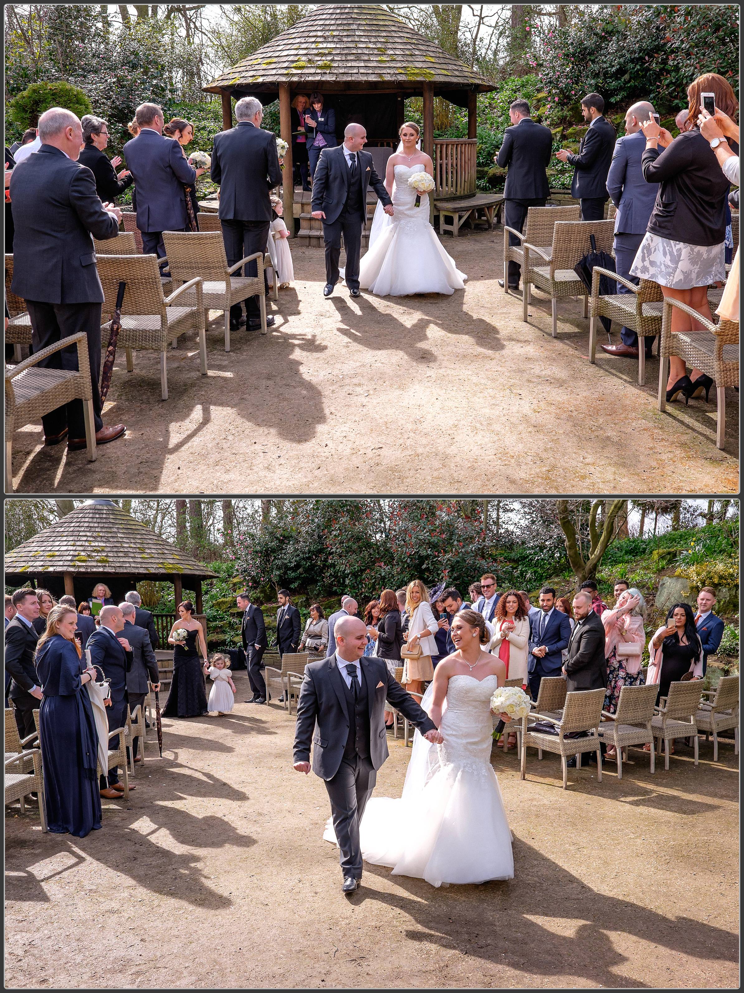 The bride and groom walking down the aisle as a married couple