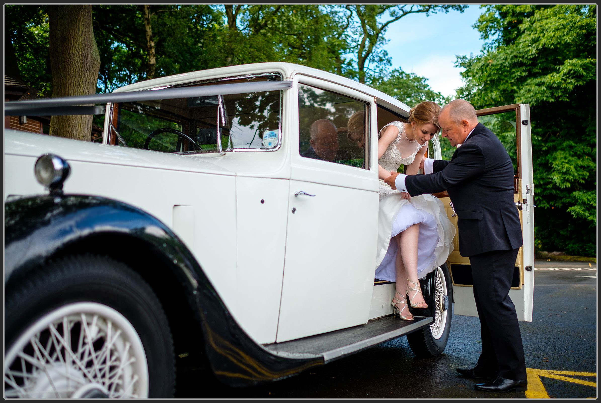 Bride getting out of the wedding car