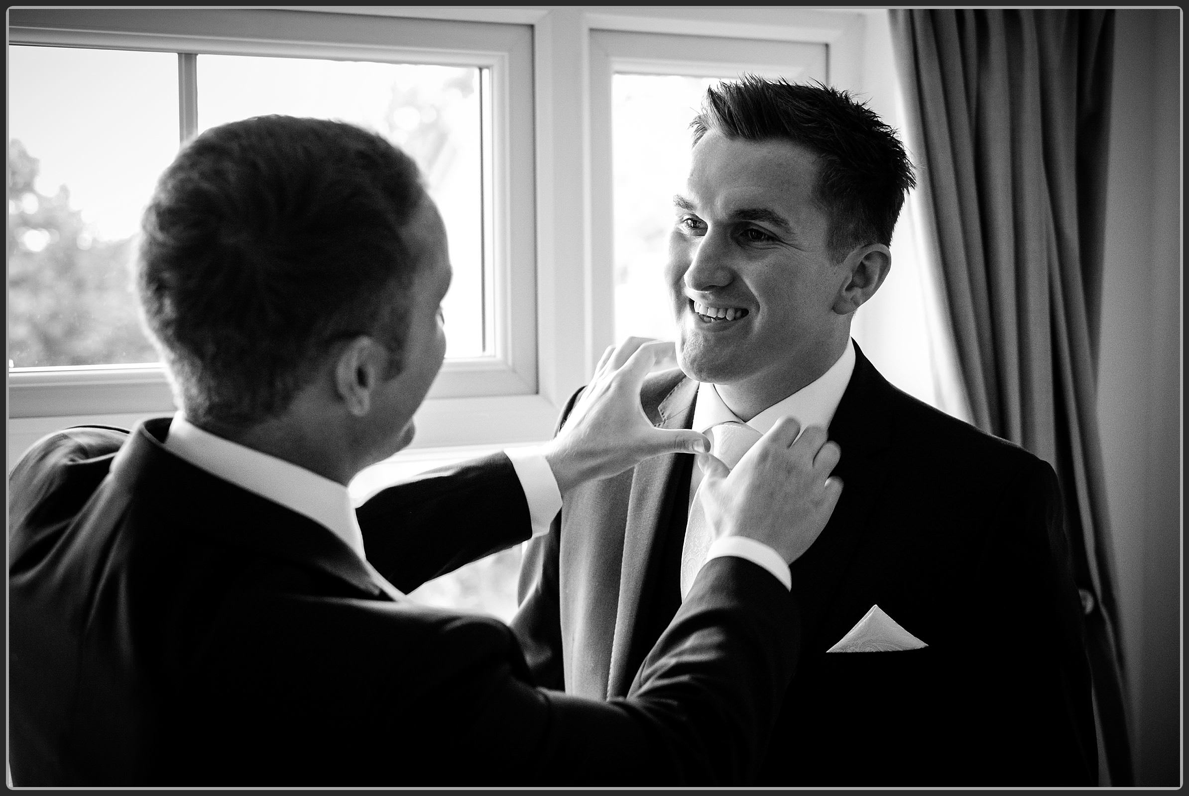 Best man helping the groom