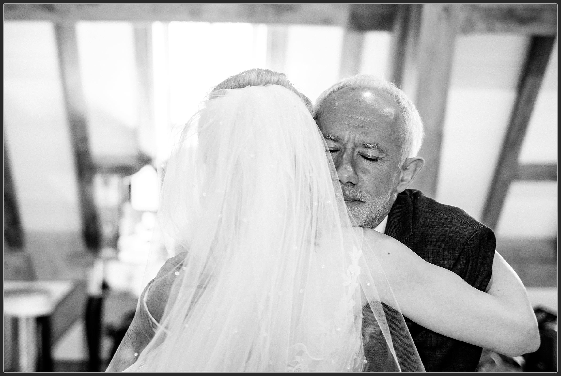Father of the bride hugging his daughter