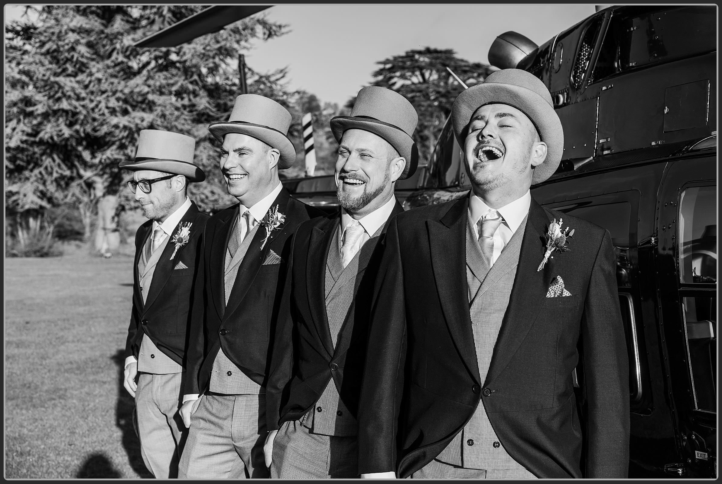 Groom and groomsmen by the helicopter laughing