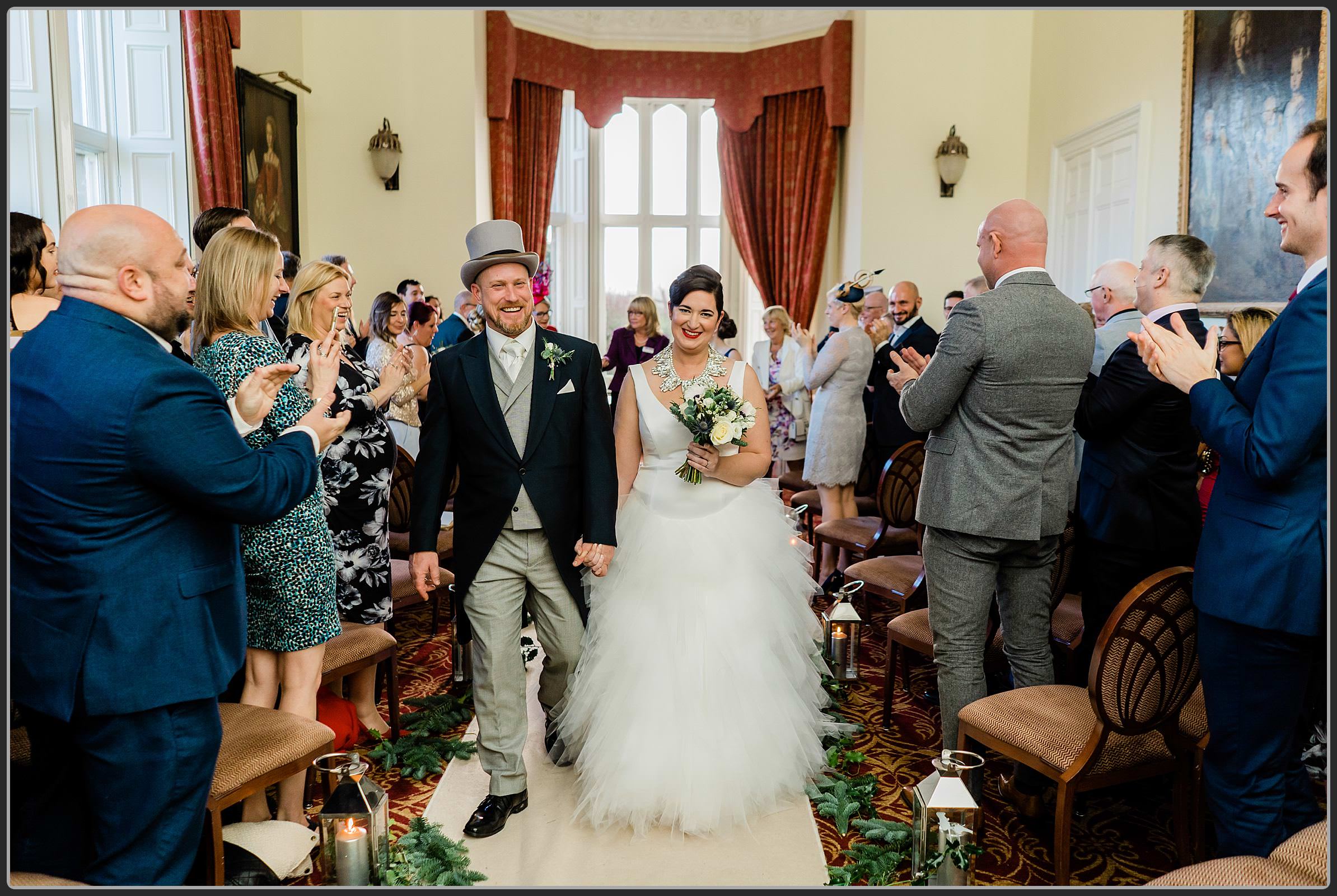 The bride and groom walking down the aisle together