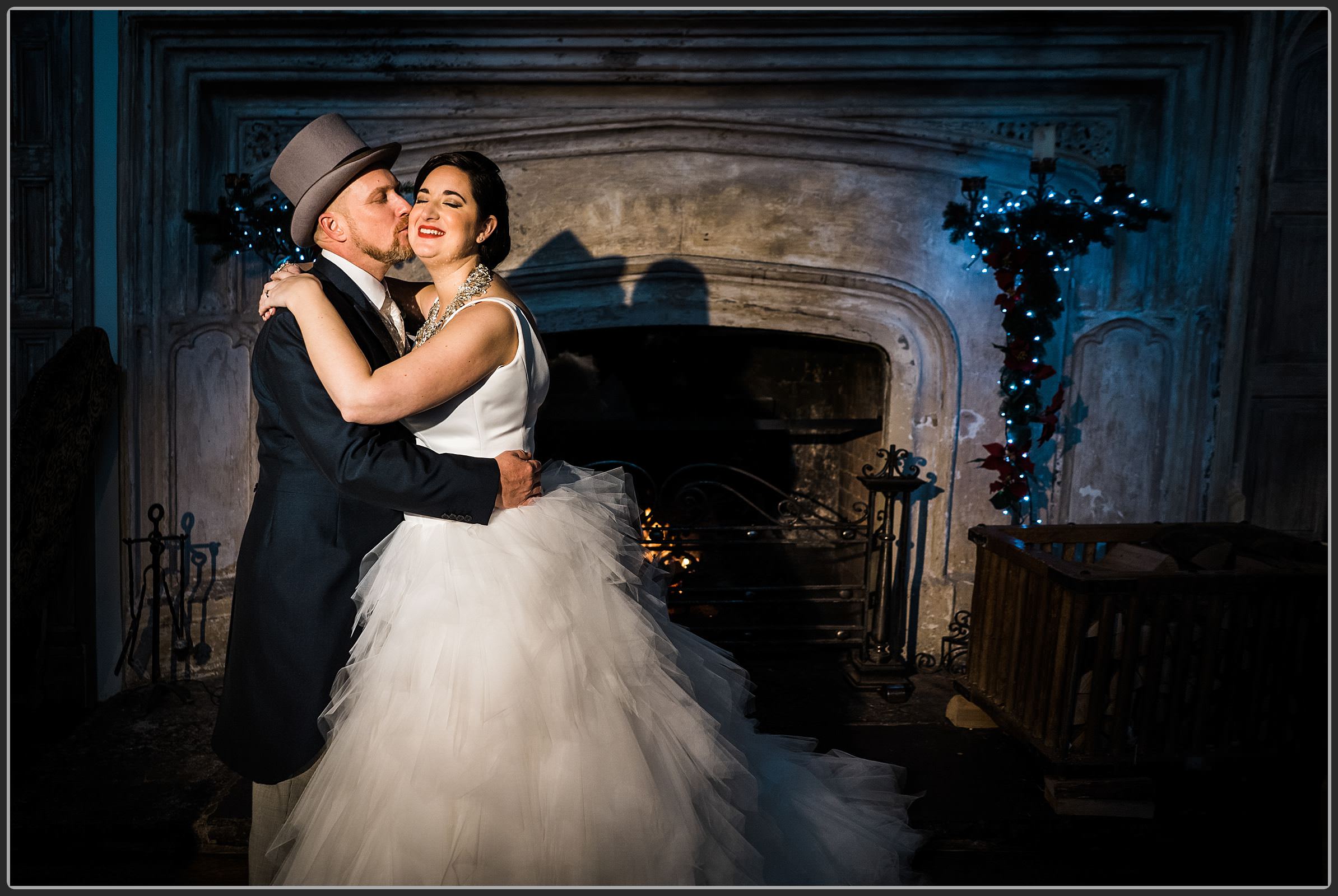 Bride and groom together by the fire place