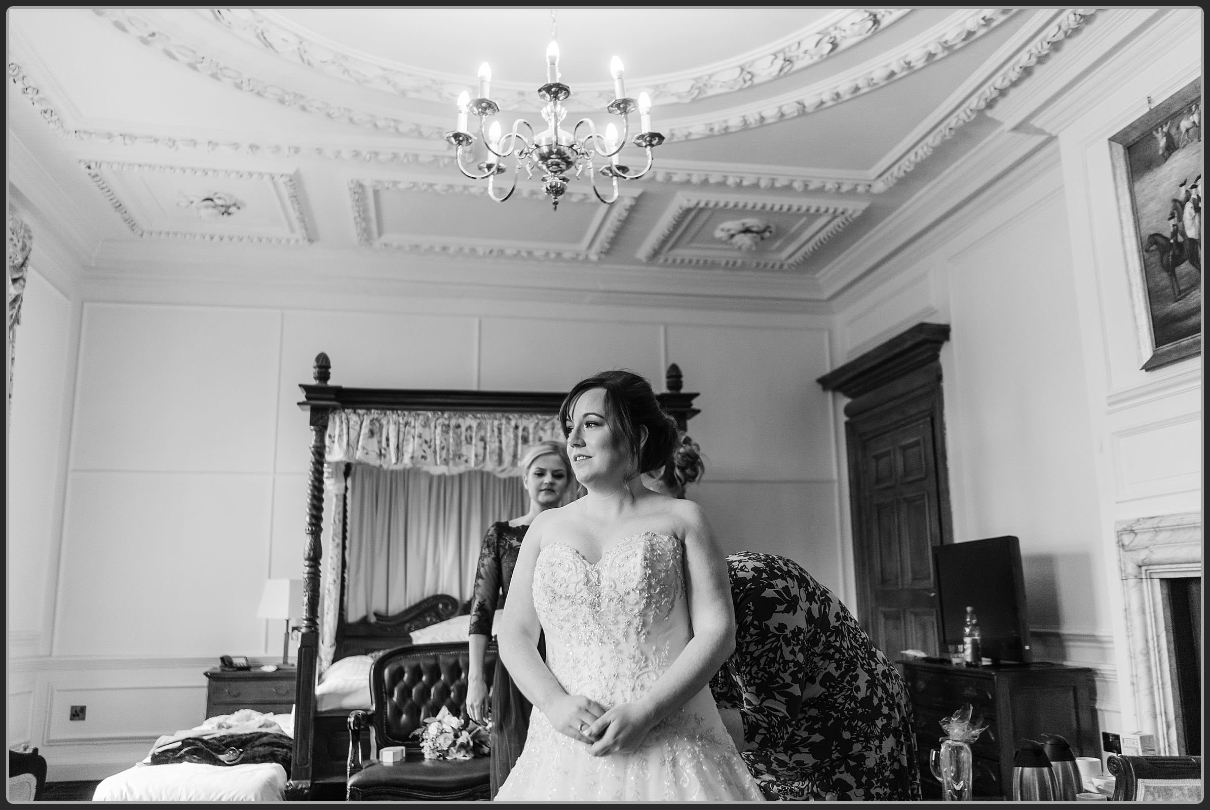 The bride having finishing touches to her dress