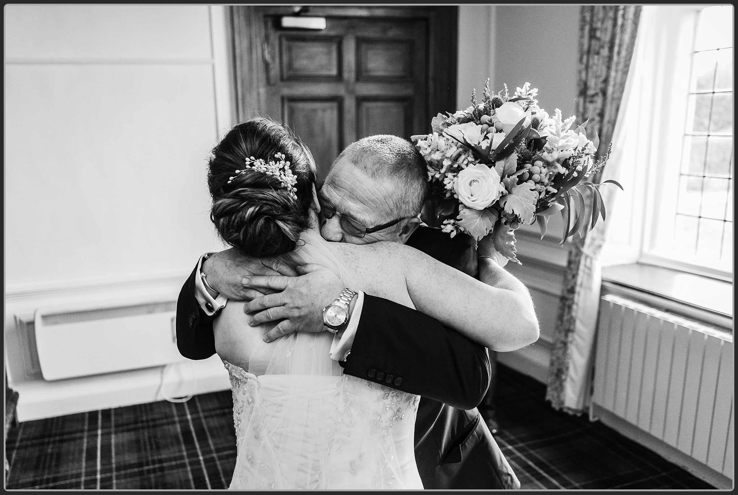 The bride and her dad share a hug
