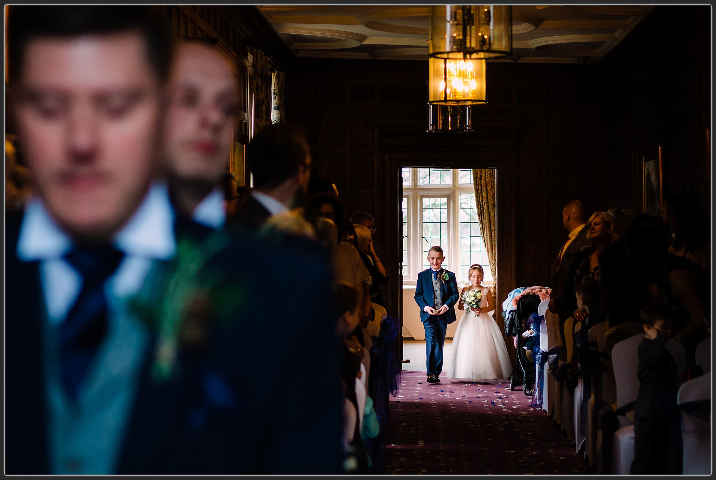 Page boy and flower girl walking down the aisle together