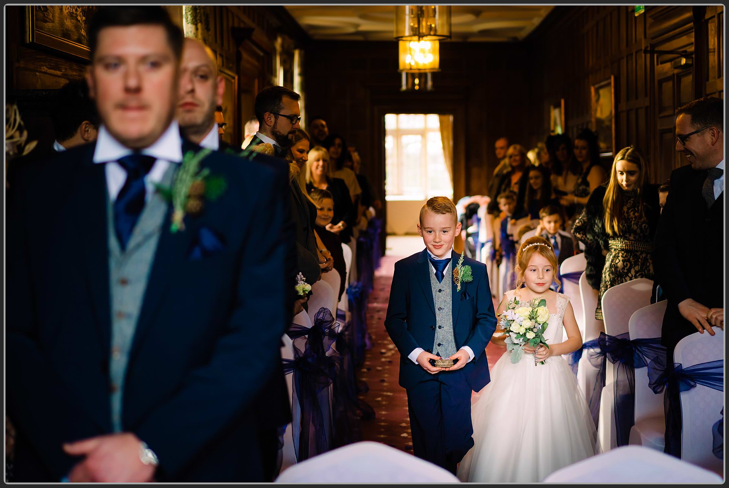 Page boy and flower girl walking down the aisle together