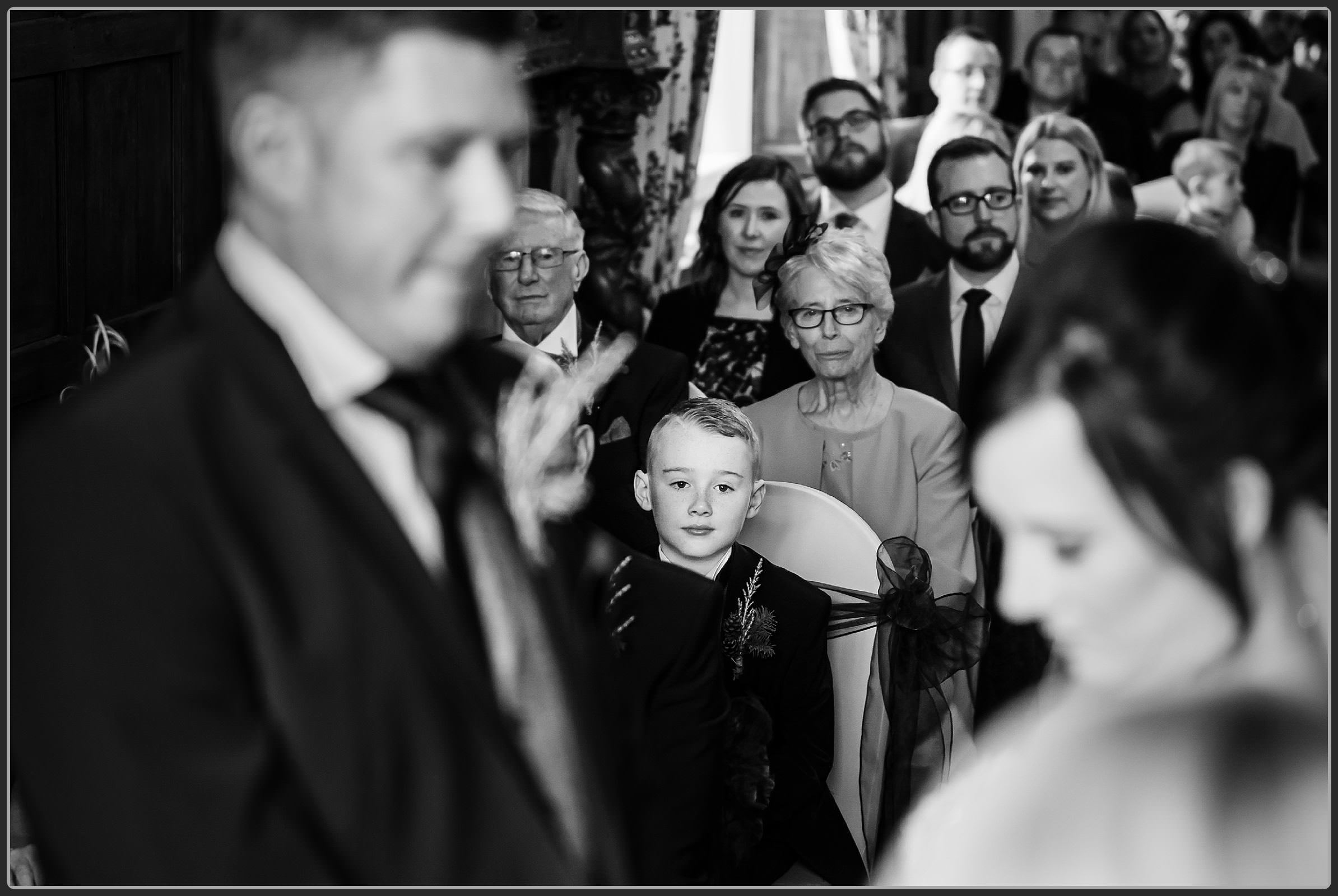 Page boy watching the wedding ceremony