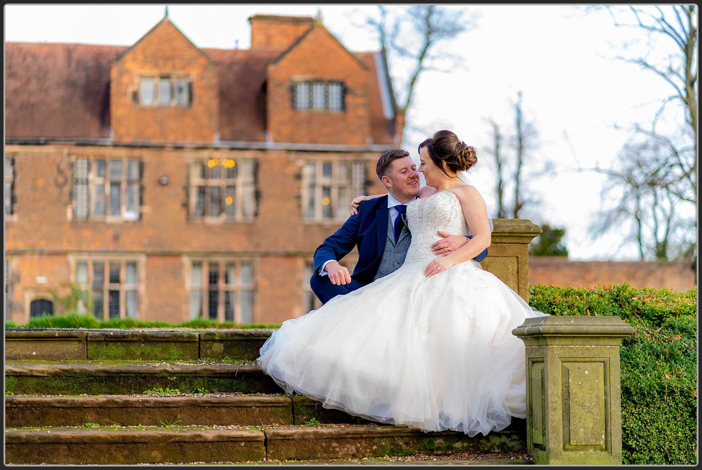 Bride and groom on the stairs at the Castle Bromwich Hall Hotel