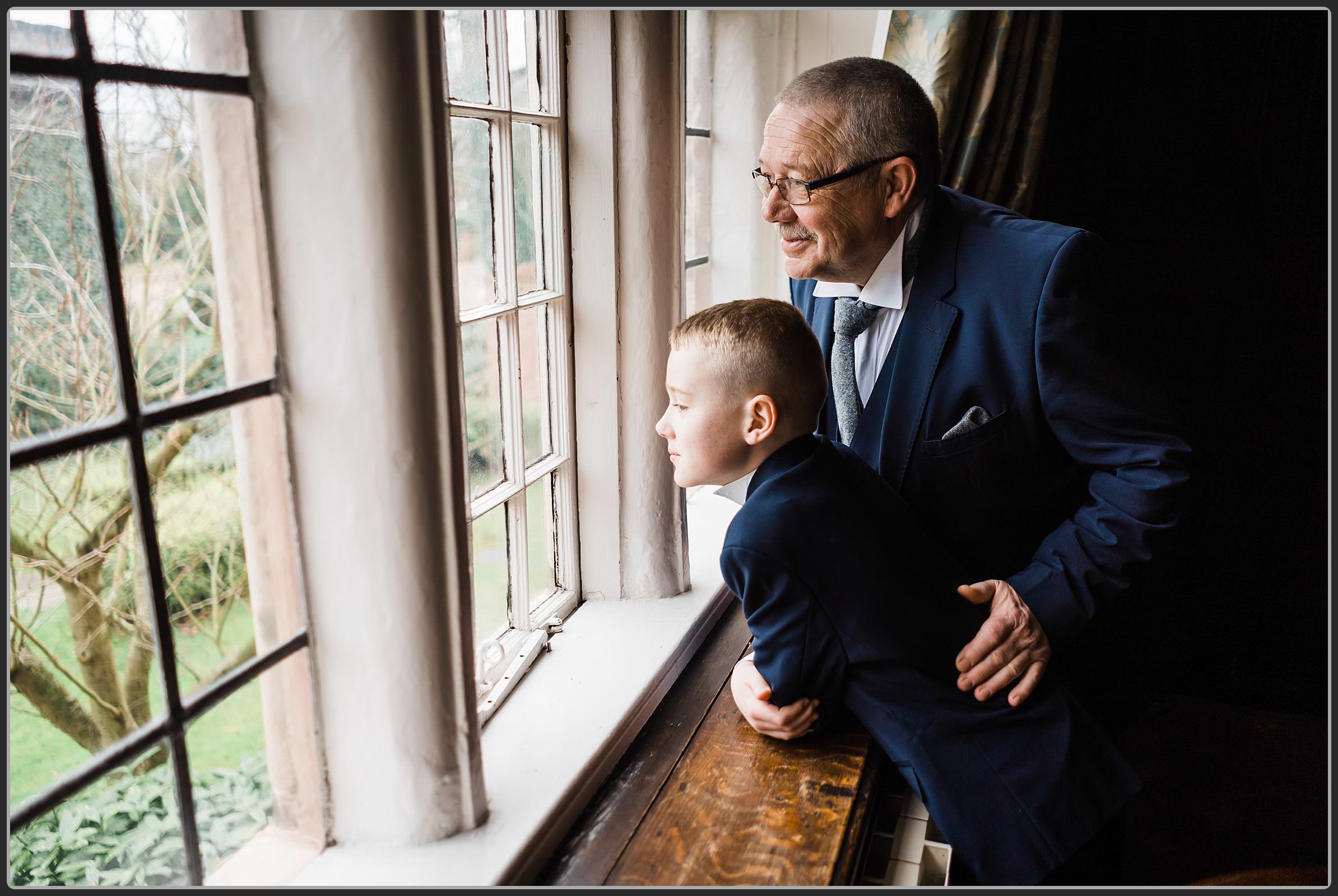 Grandad and grandson looking out the window