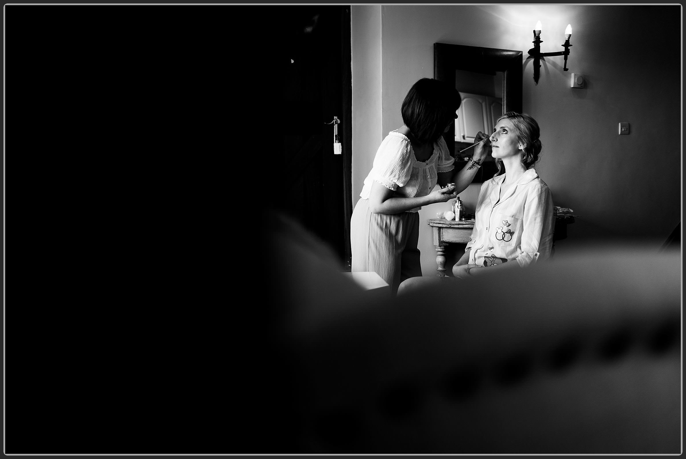 The bride having her makeup finished