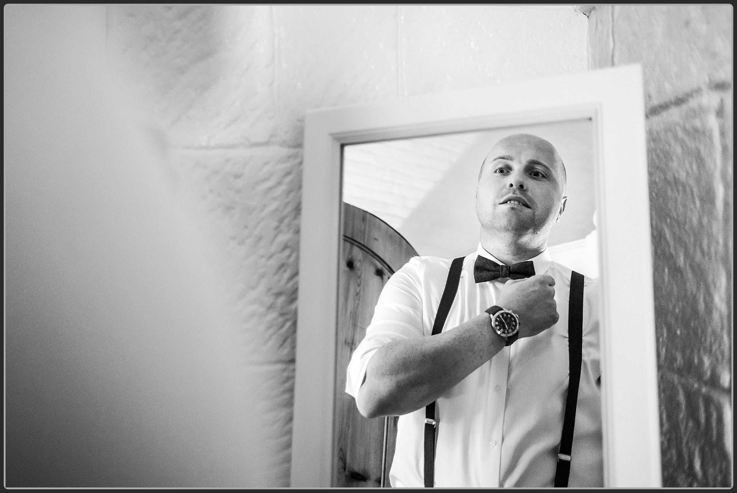 The groom adjusting his tie