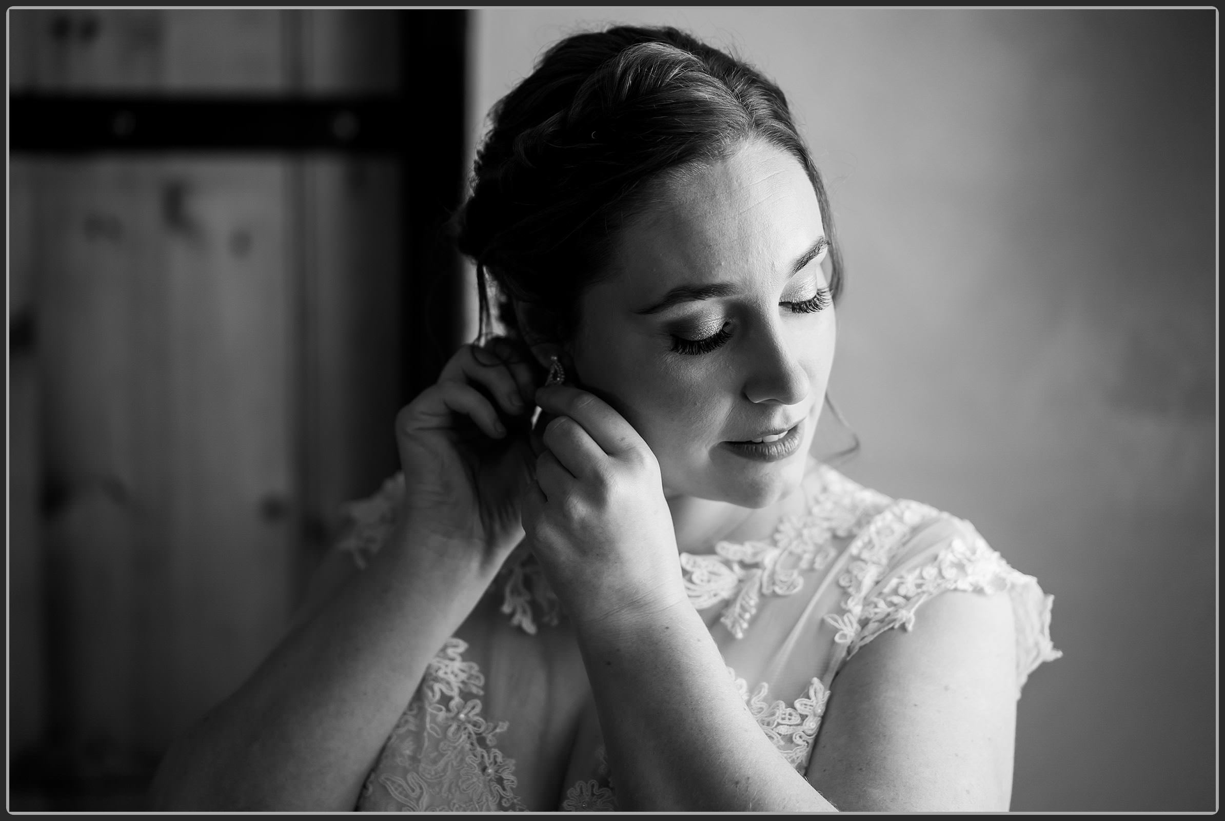 The bride putting her earrings in