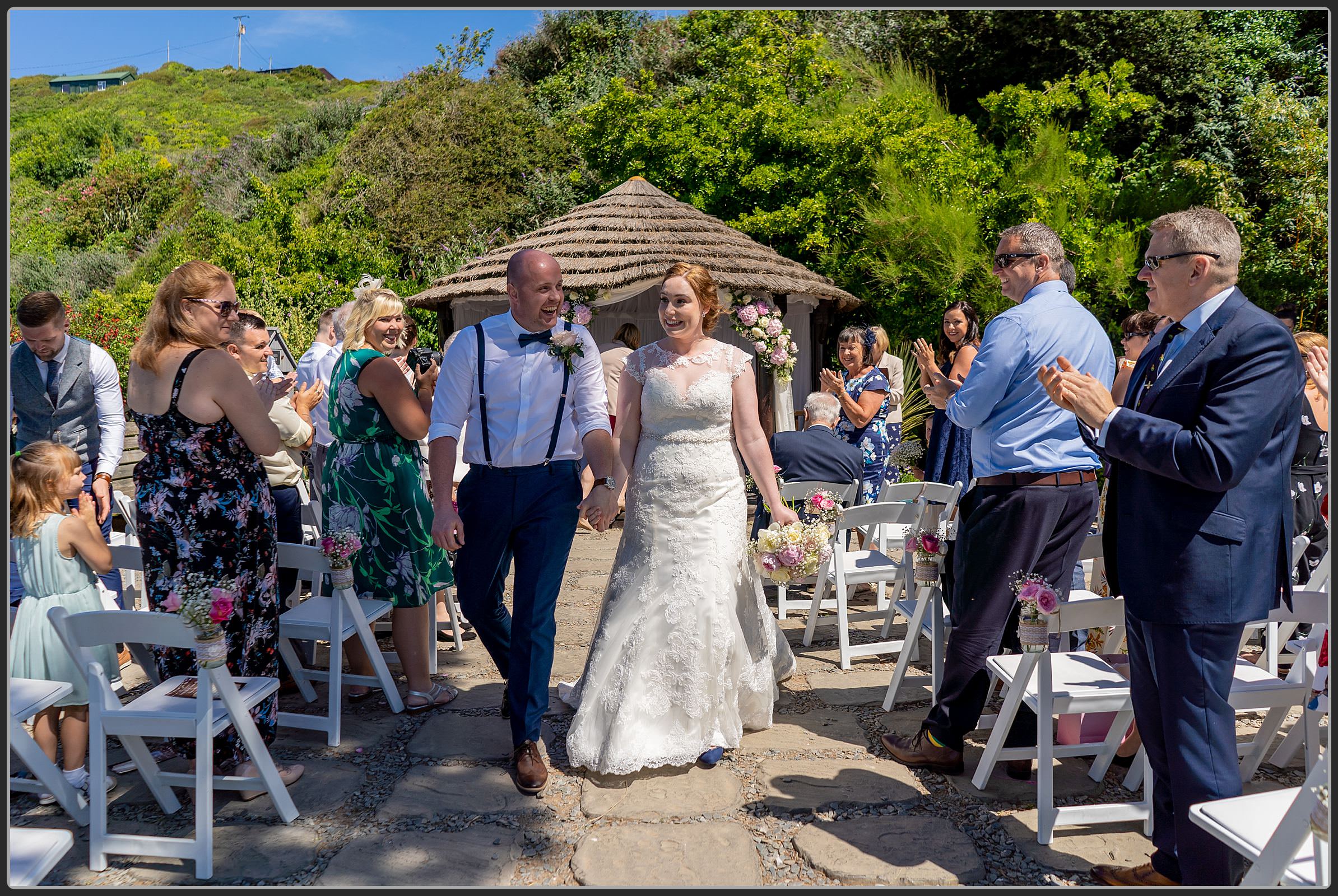 Beide and groom walking down the aisle