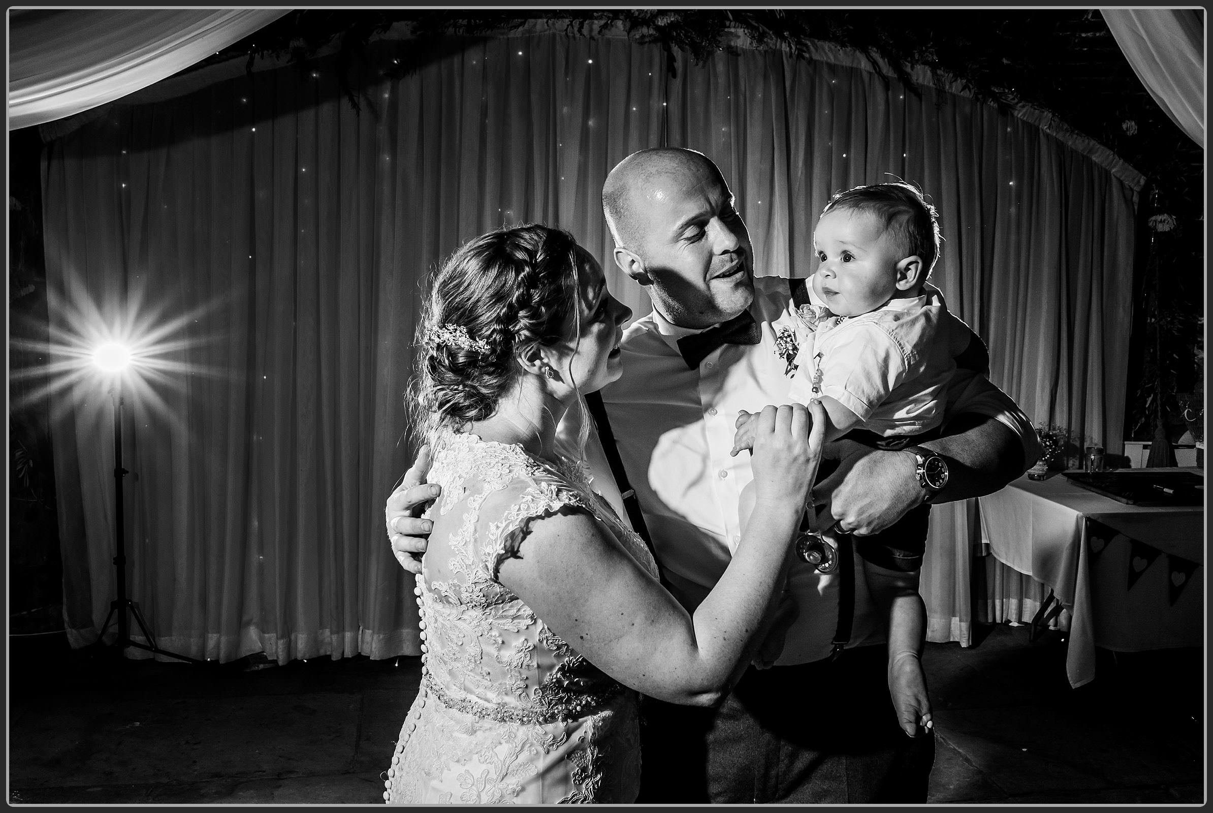 Bride and groom dancing with their son