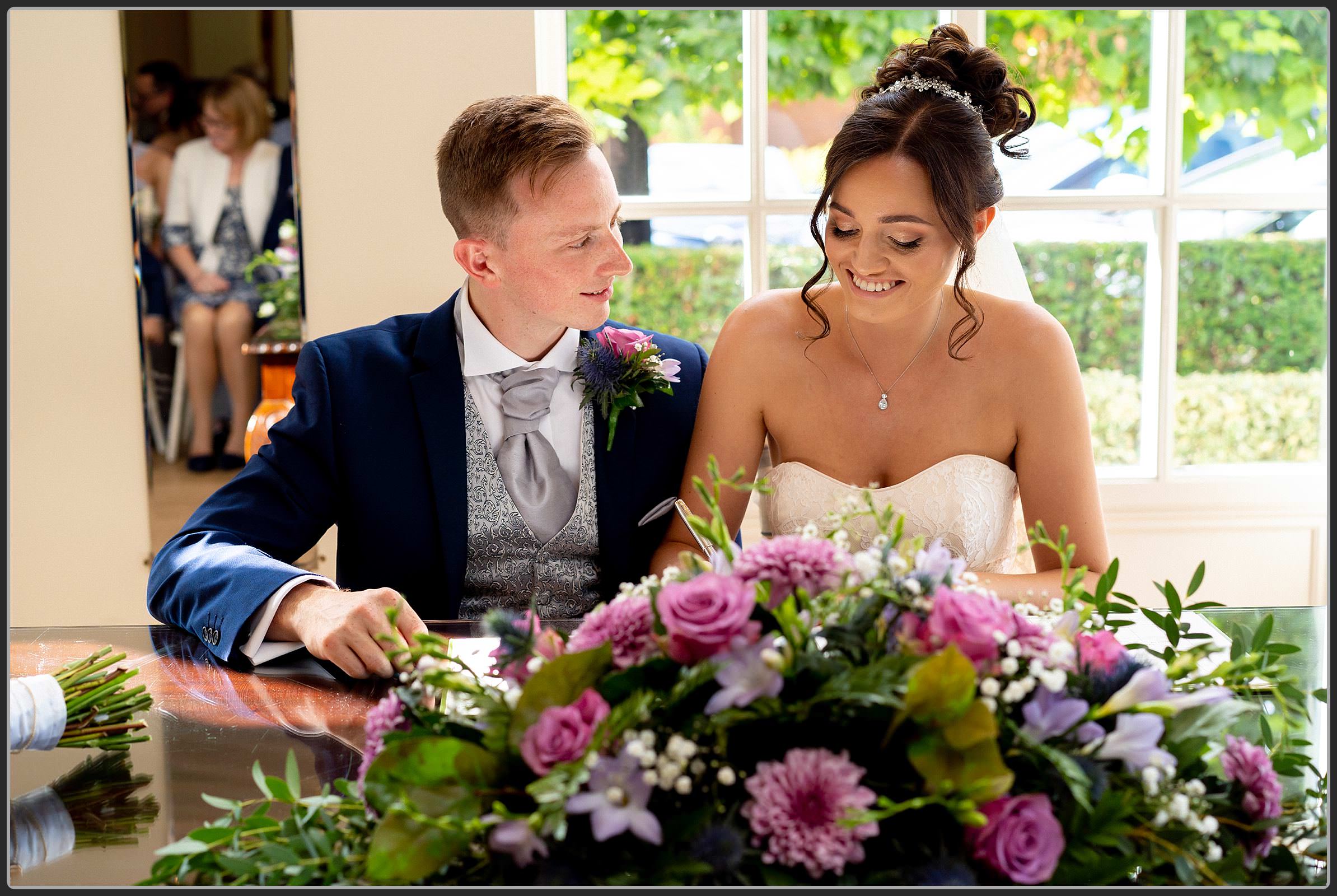 The Bride and Groom signing the register