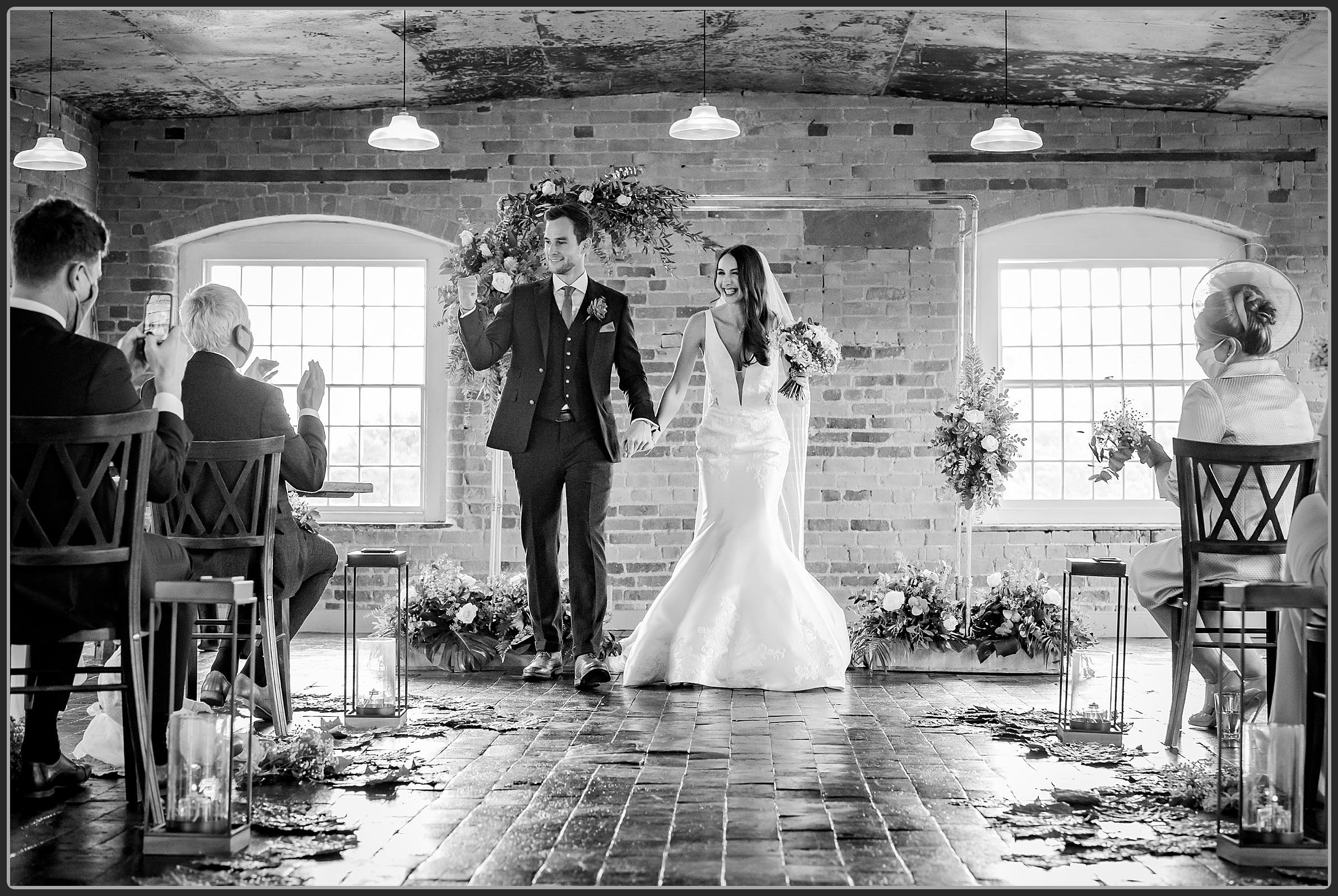 Bride and groom walking down the aisle