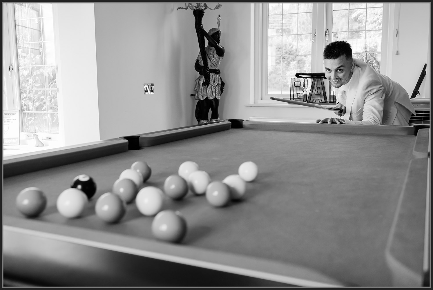 The boys playing pool before the wedding