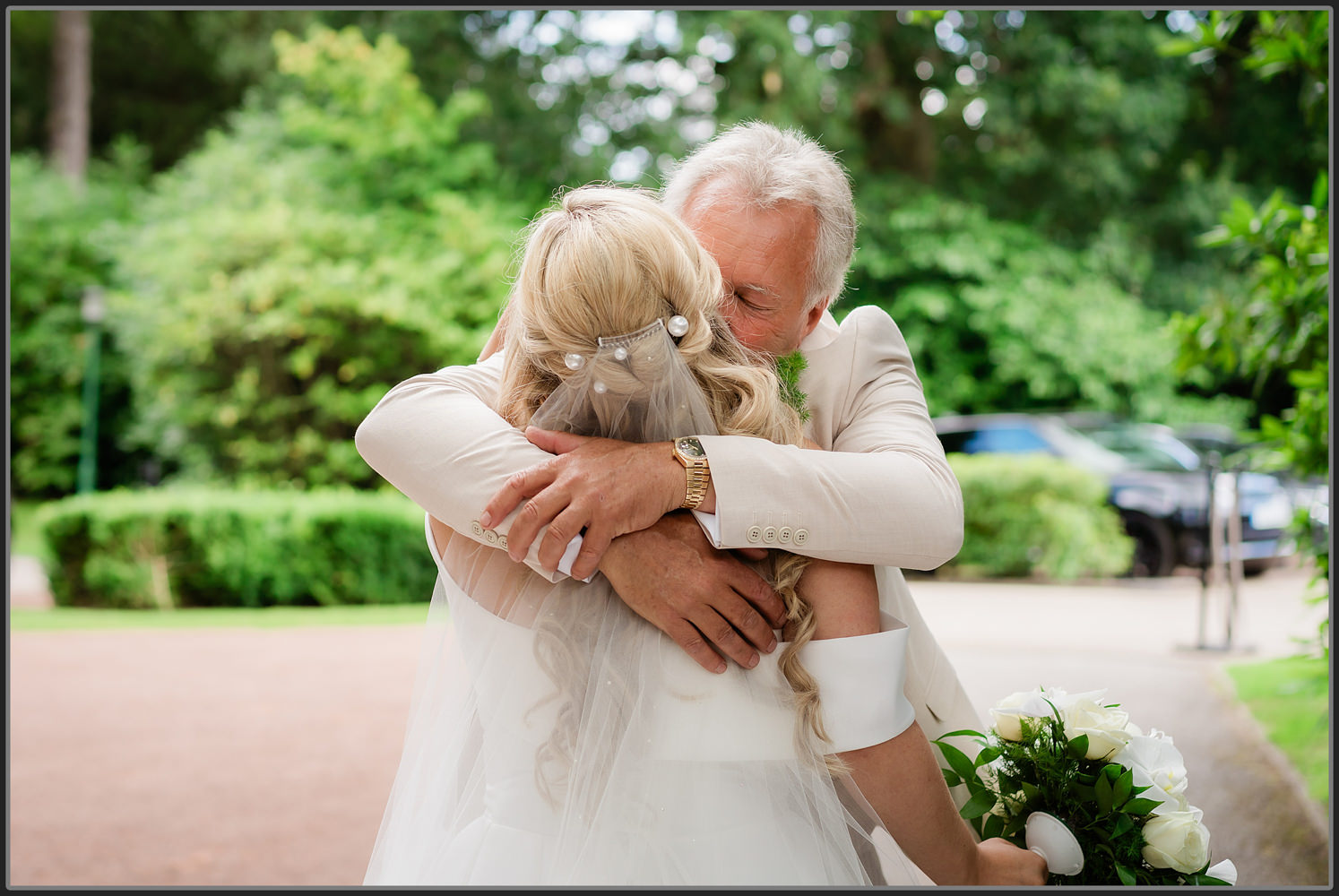 The brides dad embracing his daughter