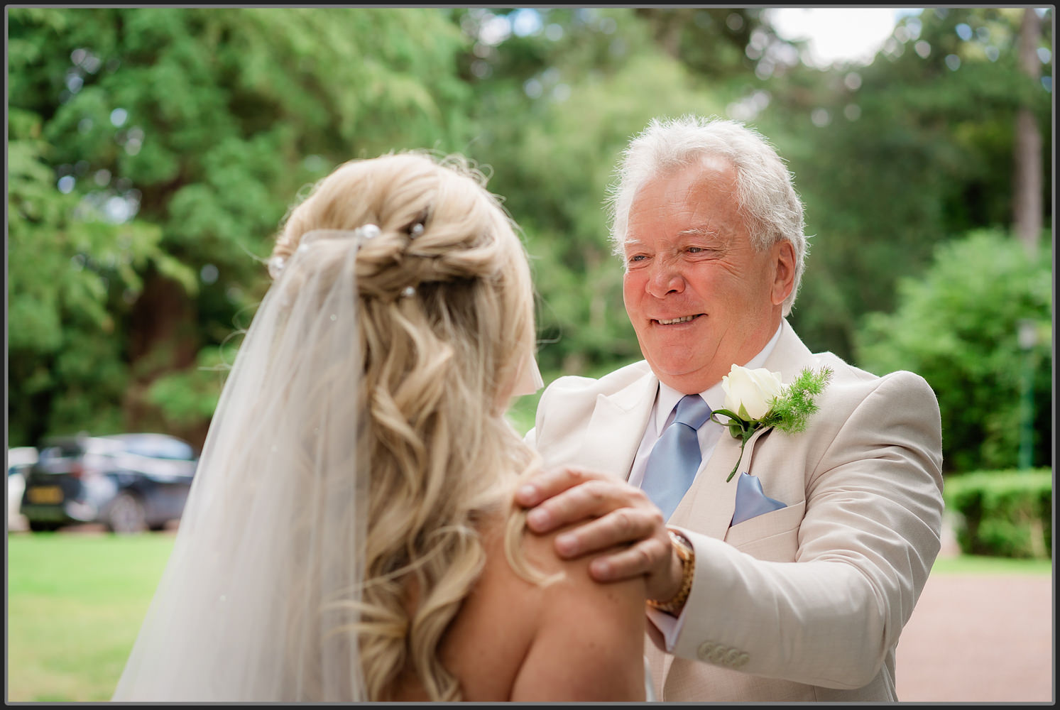 The brides dad smiling after seeing his daughter Emilie
