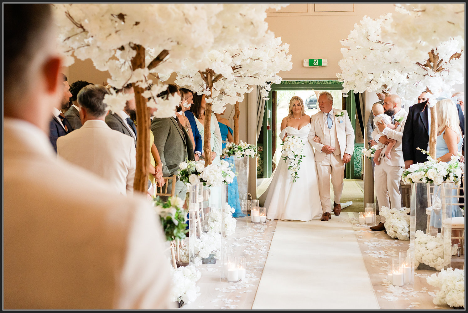 Emilie and her dad walking down the isle at Hampton Manor