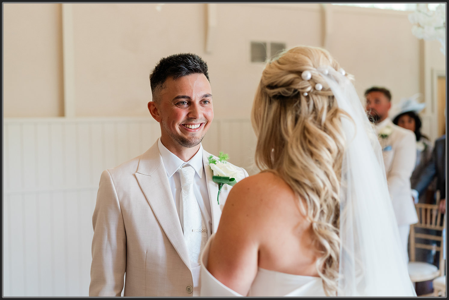 The groom laughing during the ceremony