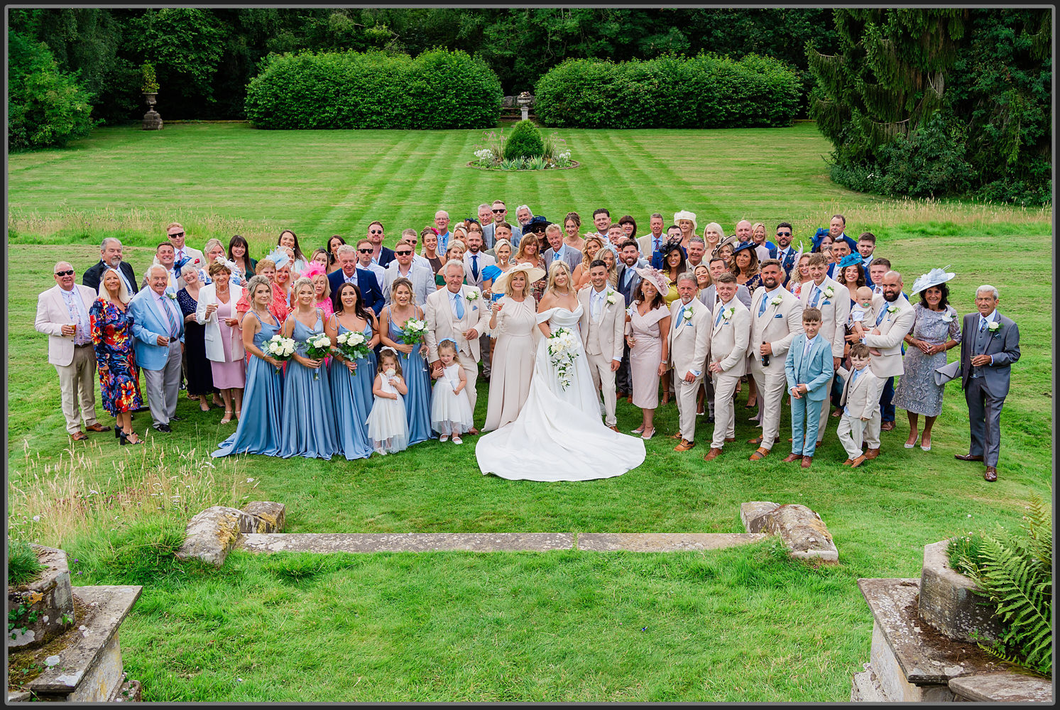 The group photo of the bride and groom and their wedding guests and family