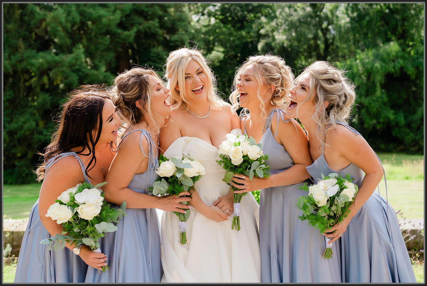 The bridesmaids laughing during the group photos at Hampton Manor