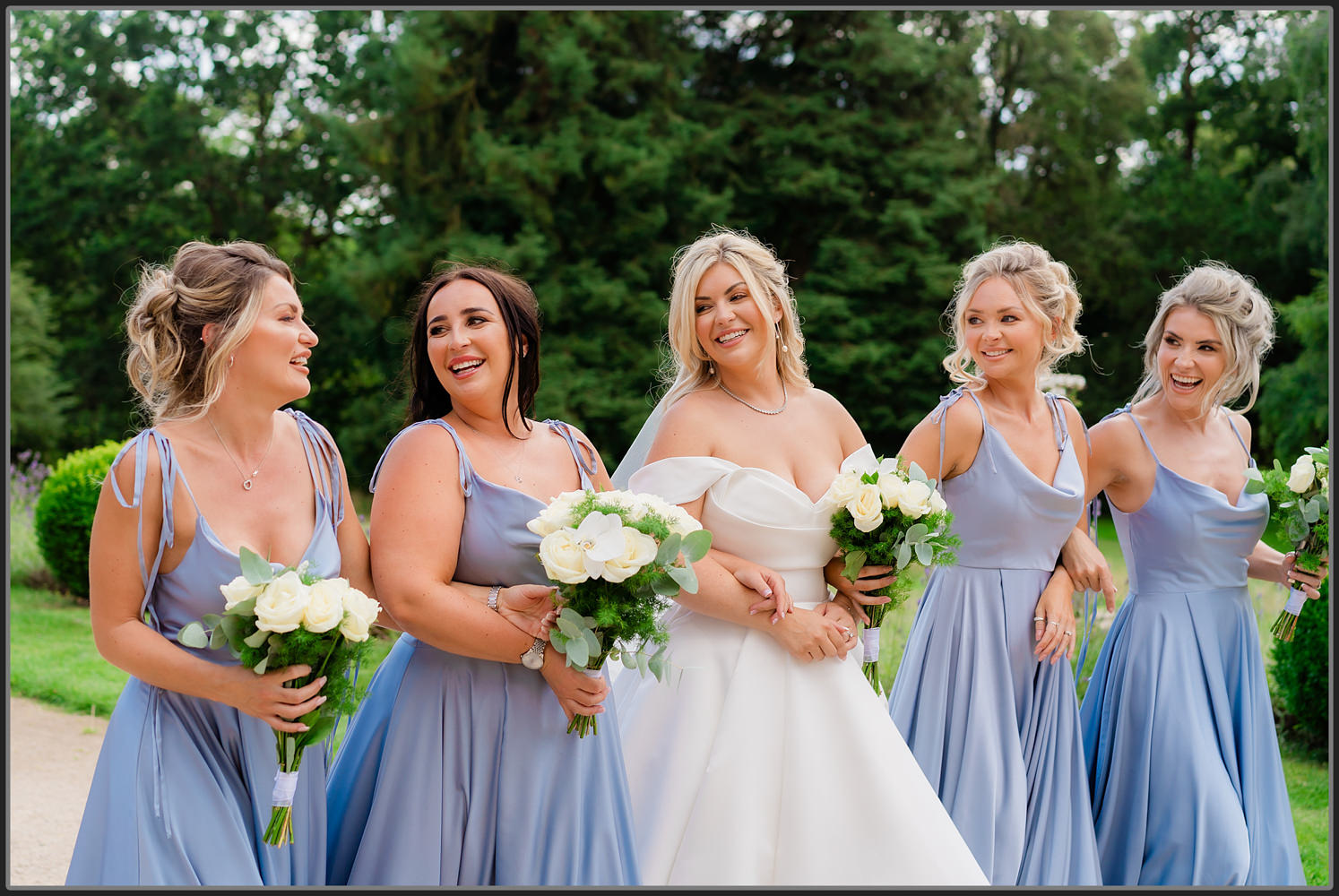 The bridesmaids walking around the grounds at Hampton Manor